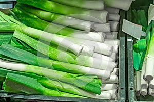 Bunch of fresh organic leek on the shelve inÂ a market